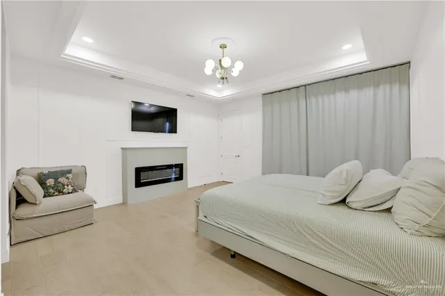 a bedroom with a large bed and a flat screen tv