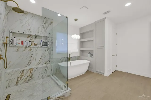 a spacious bathroom with a bathtub sink and toilet