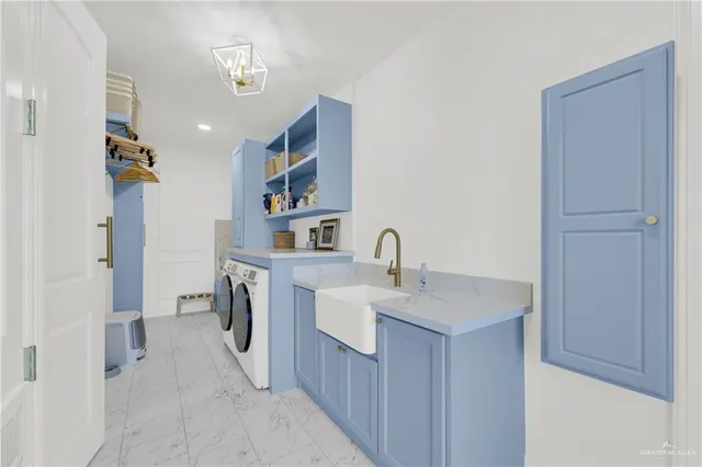 a kitchen with a sink appliances and cabinets