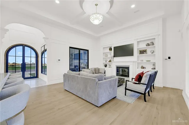 a living room with furniture a fireplace and a flat screen tv