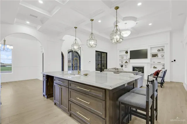 a large kitchen with a table and chairs