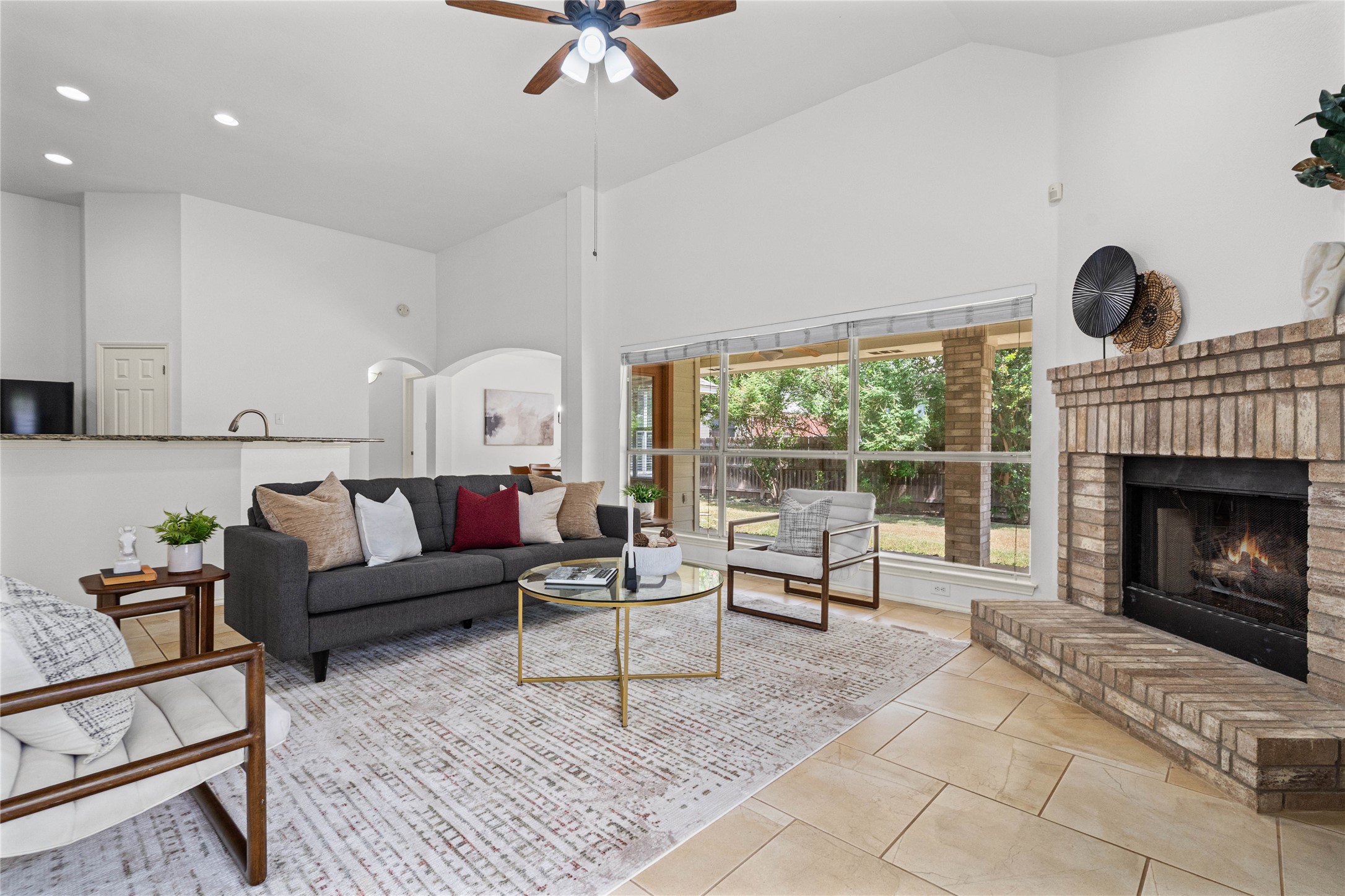 2920 Warwick Way Austin, TX 78748 - Photo 10 of 36 A spacious living room features soaring ceilings, a cozy fireplace, and abundant natural light