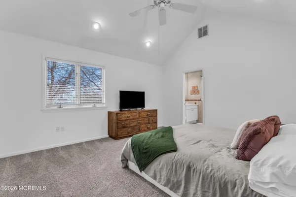 a bedroom with a bed and a television