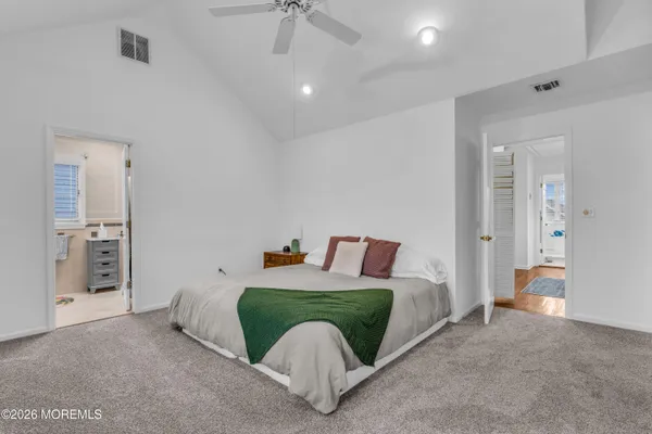 a bedroom with a bed and ceiling fan