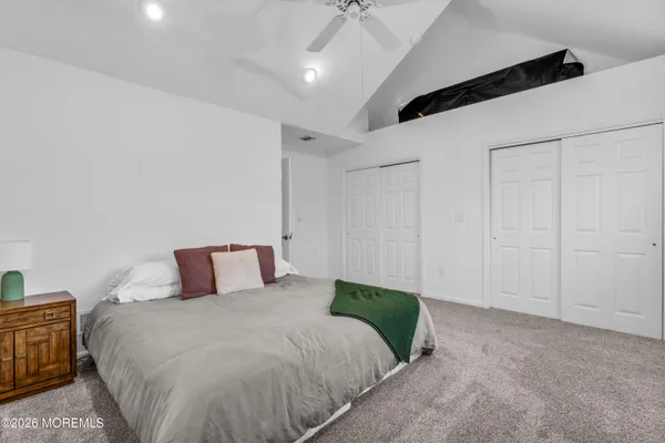 a bedroom with a bed and a night stand