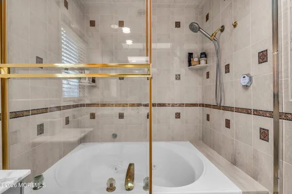 a bathroom with a bathtub and a shower