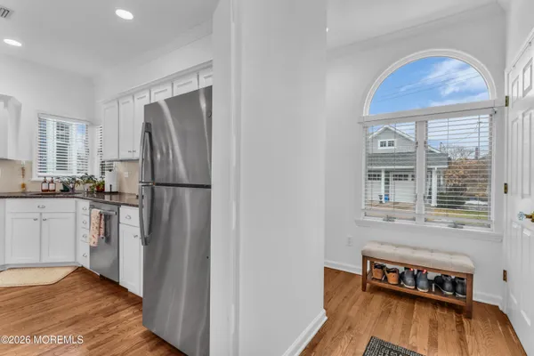 a kitchen with refrigerator cabinets and wooden floor