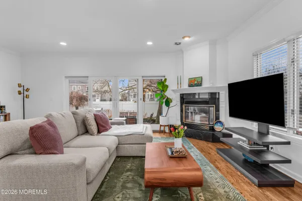 a living room with fireplace furniture and a flat screen tv