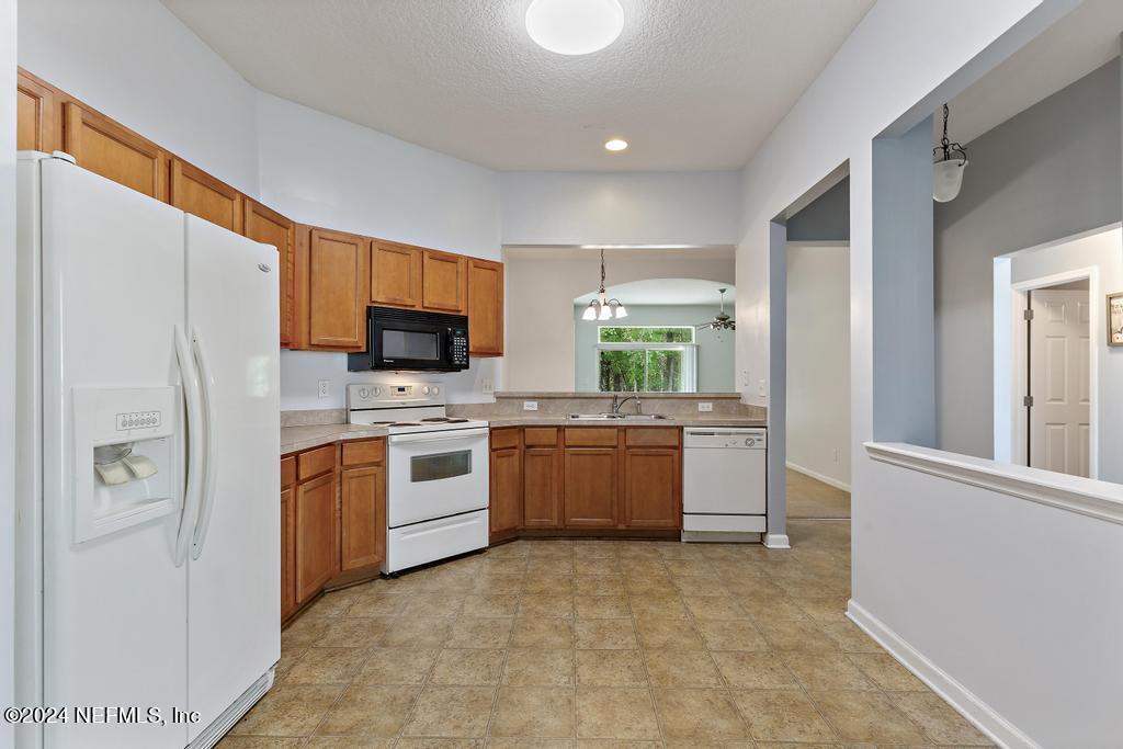 5902 Round Table Road Jacksonville, FL 32254 - Photo 11 of 44 a kitchen with stainless steel appliances a refrigerator sink and microwave