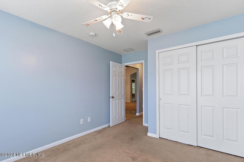 5902 Round Table Road Jacksonville, FL 32254 - Photo 16 of 44 an empty room with a ceiling fan and a fan