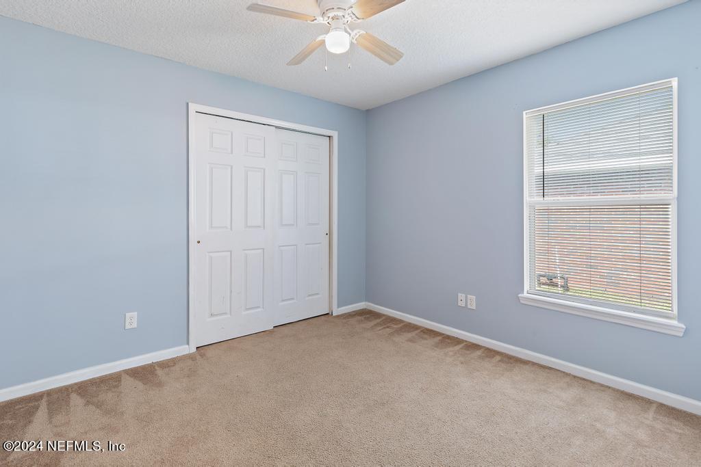 5902 Round Table Road Jacksonville, FL 32254 - Photo 21 of 44 an empty room with a window and a fan