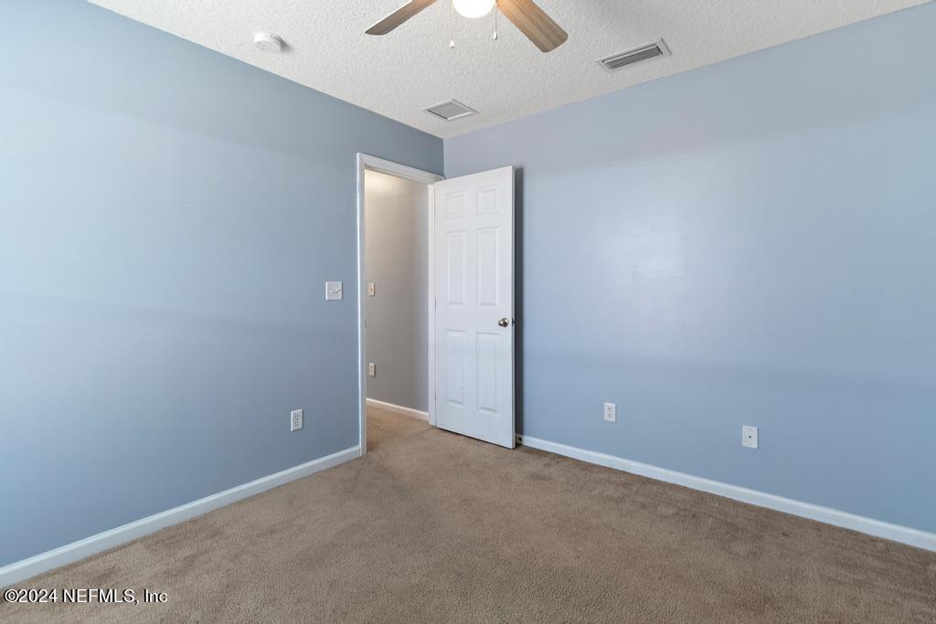 5902 Round Table Road Jacksonville, FL 32254 - Photo 22 of 44 an empty room with a chandelier fan