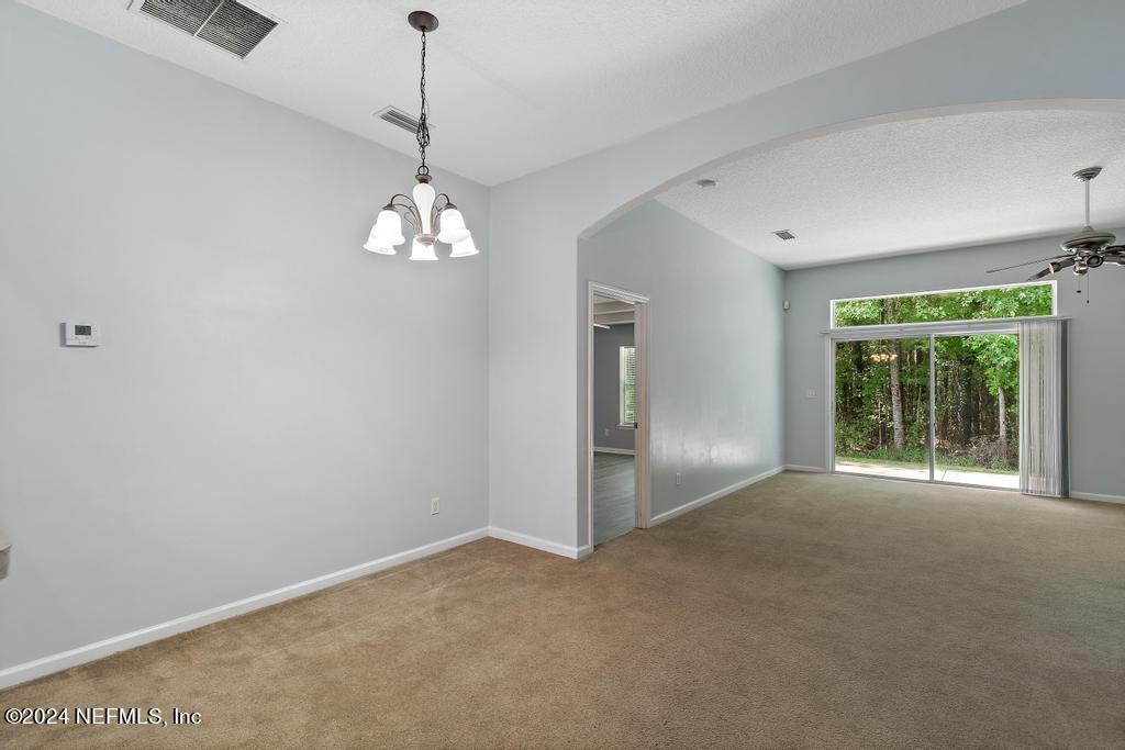 5902 Round Table Road Jacksonville, FL 32254 - Photo 24 of 44 a view of a livingroom with a chandelier fan and windows