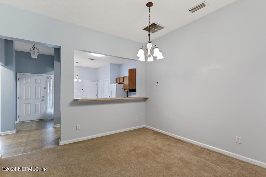 5902 Round Table Road Jacksonville, FL 32254 - Photo 25 of 44 wooden floor in an empty room with a mirror