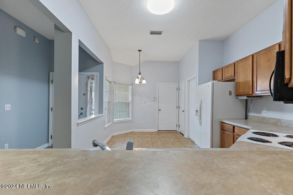 5902 Round Table Road Jacksonville, FL 32254 - Photo 9 of 44 a large white kitchen with a stove a sink and a refrigerator