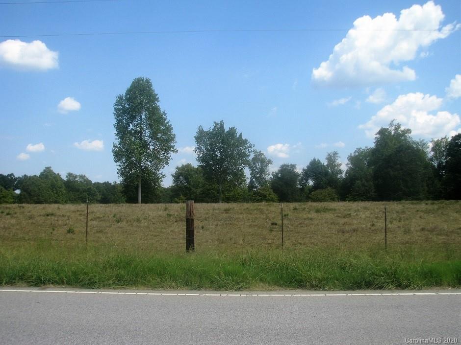 a view of a field with a tree in a yard