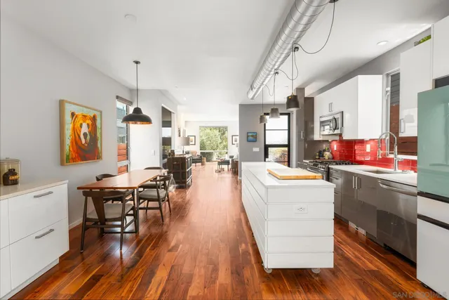 a very nice looking living room with wooden floor and furniture