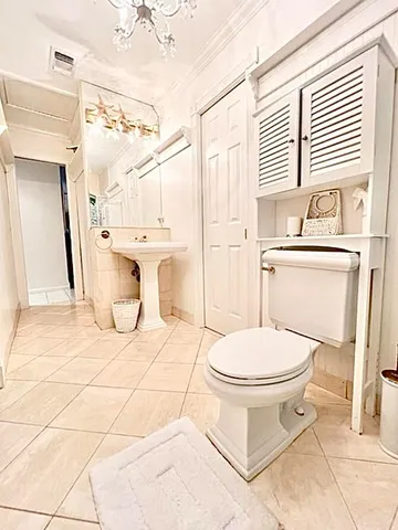 a bathroom with a toilet a sink and a mirror