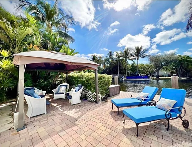 a view of a patio with couches chairs and a potted plant