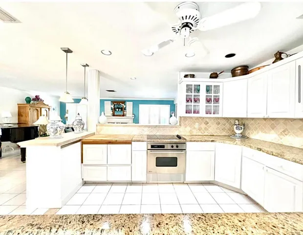 a kitchen with stainless steel appliances kitchen island granite countertop a sink and cabinets