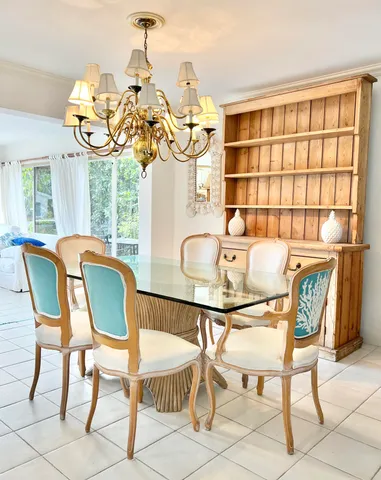 a dining room filled chandelier and wooden floor