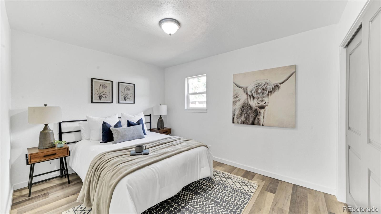 660 Meade Street Denver, CO 80204 - Photo 17 of 25 a bedroom with bed and painting on the wall