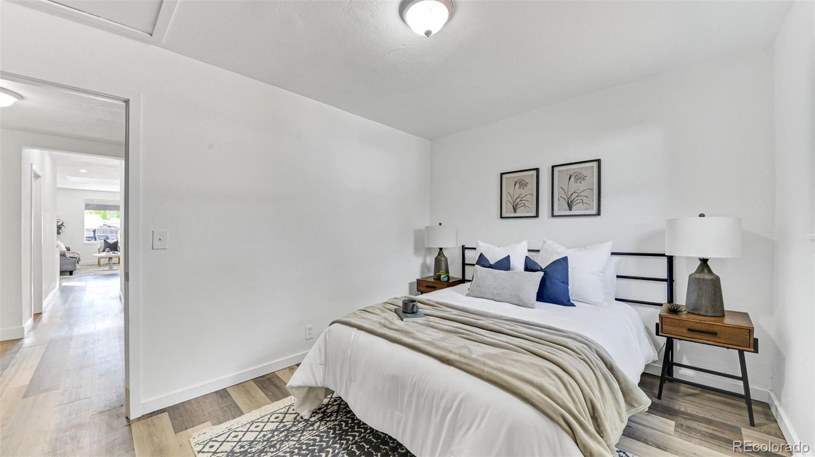 660 Meade Street Denver, CO 80204 - Photo 18 of 25 a bedroom with a bed and a lamp with the wooden floor