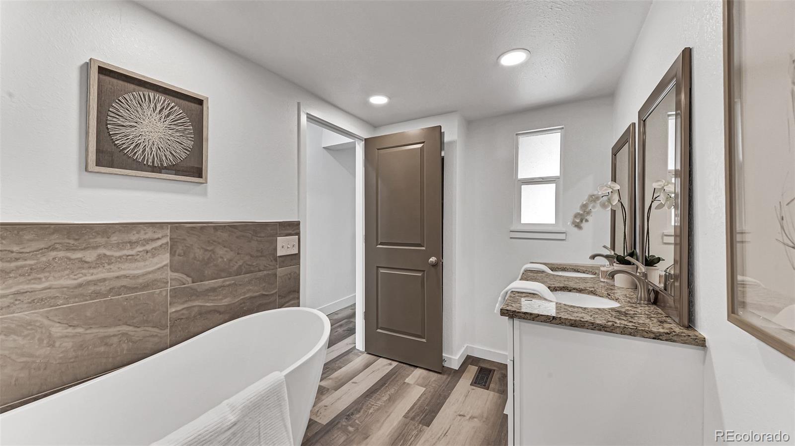 660 Meade Street Denver, CO 80204 - Photo 21 of 25 a bathroom with a tub sink and mirror