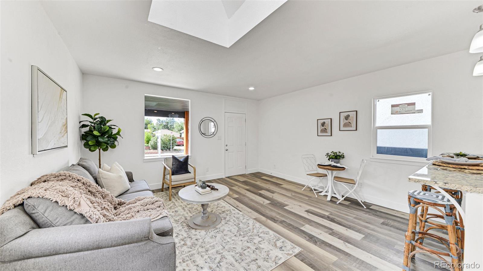 660 Meade Street Denver, CO 80204 - Photo 10 of 25 a living room with furniture or couch and a potted plant