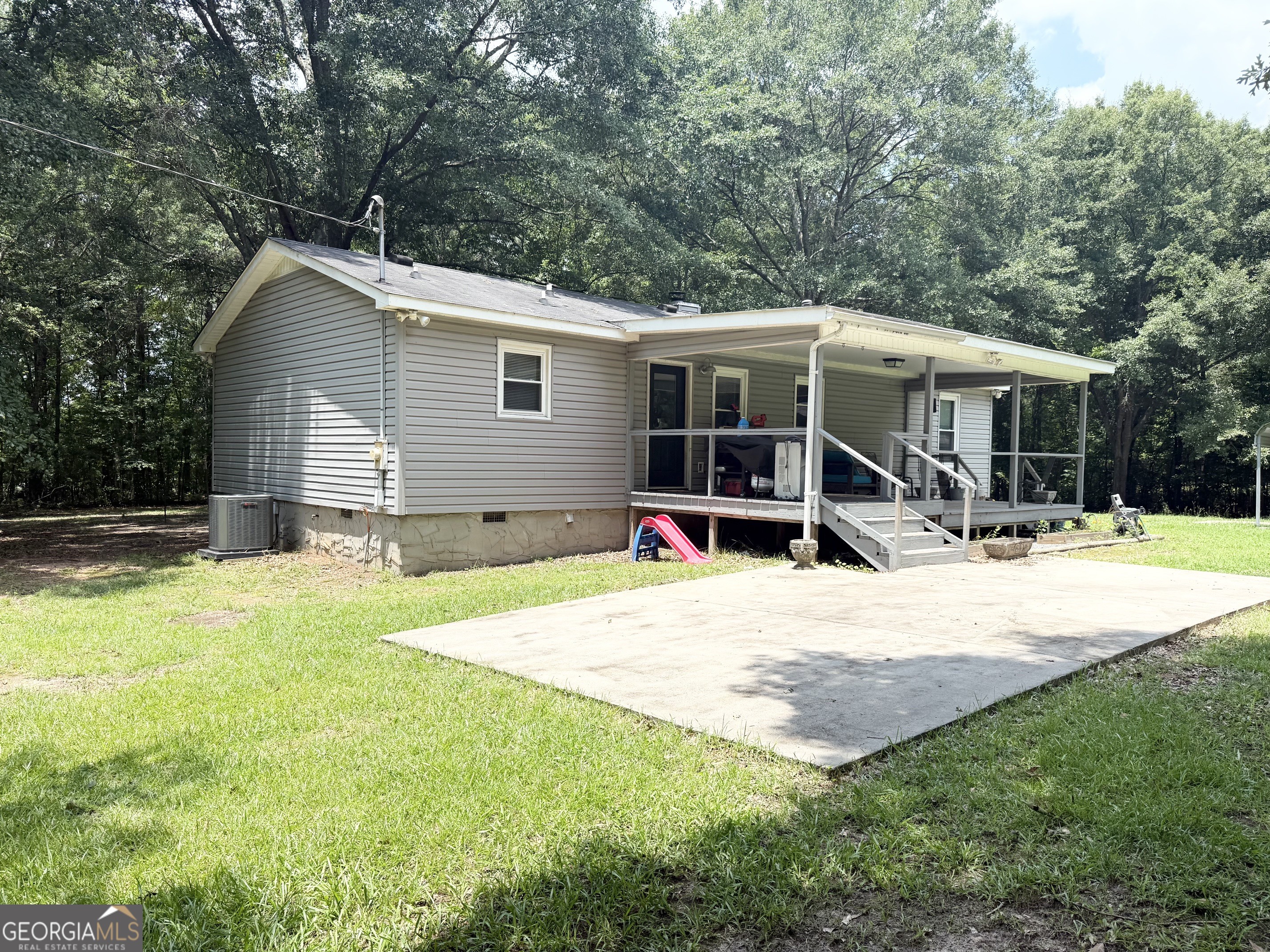 62 Melvin Harris Road Manchester, GA 31816 - Photo 45 of 52 a view of a house with a yard patio and slide