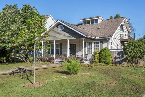 a view of a house with a yard and sitting area
