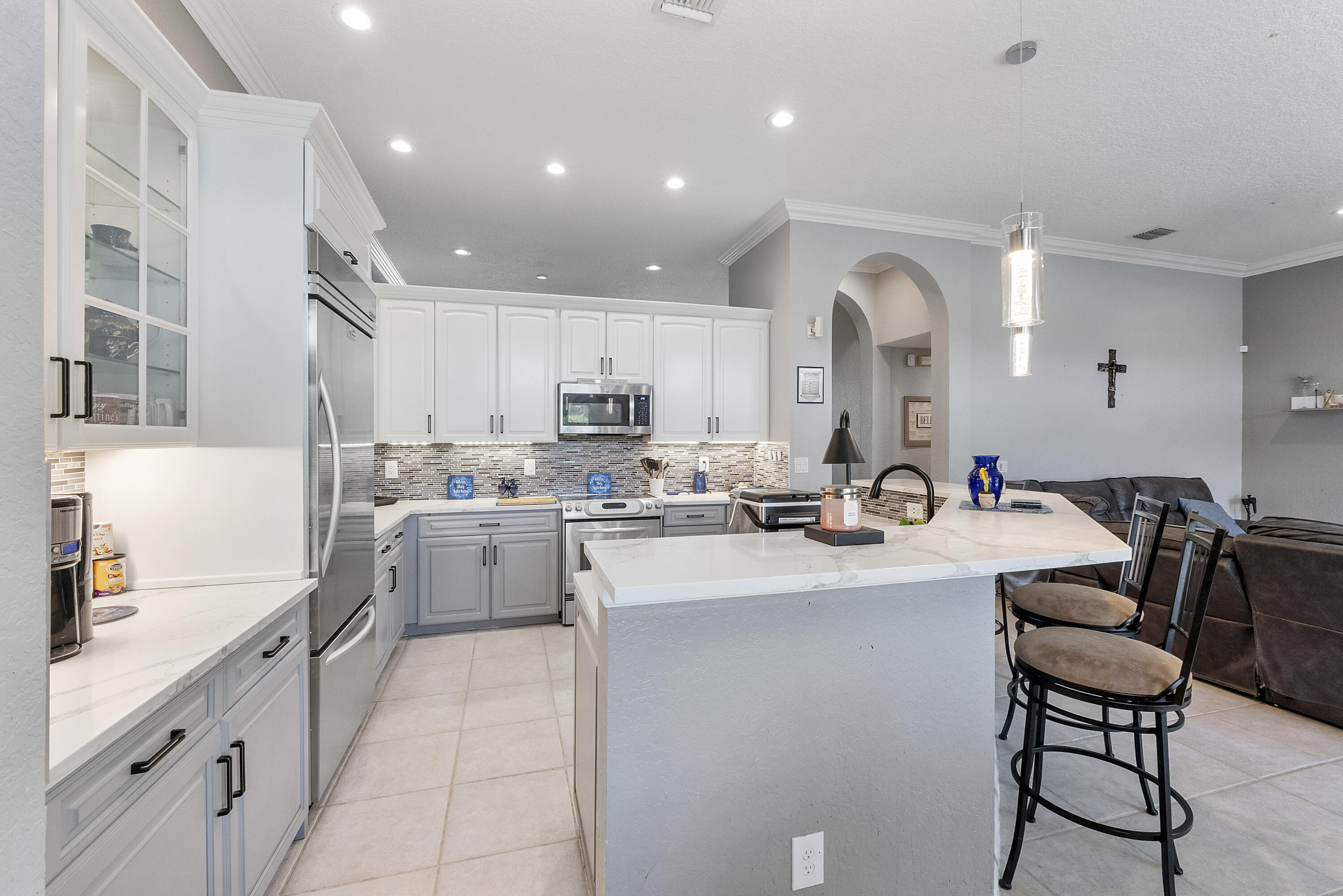 12328 St Simon Drive Boca Raton, FL 33428 - Photo 13 of 52 a kitchen with appliances a sink and cabinets