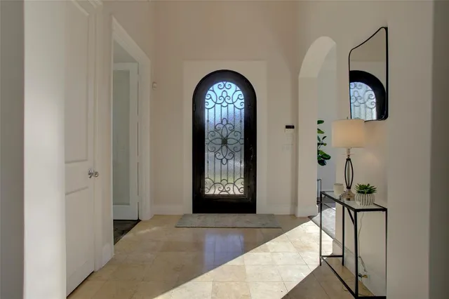 a view of a hallway with entryway wooden floor and front door
