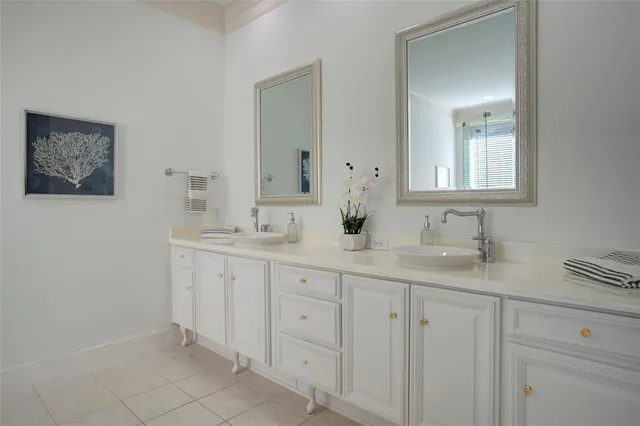 a bathroom with double sink and a mirror