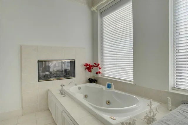 a white bath tub sitting next to a window