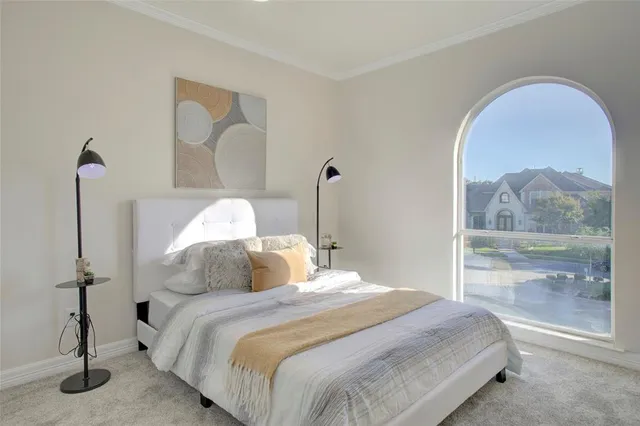 a bedroom with a bed and a painting on the wall