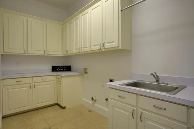 a kitchen with white cabinets and a sink