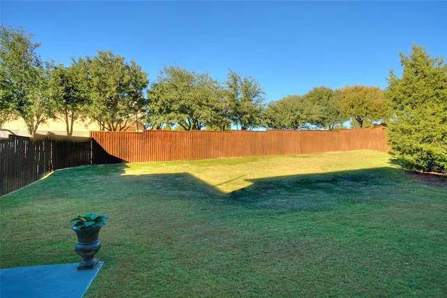 a view of a lake with a yard and mountain view