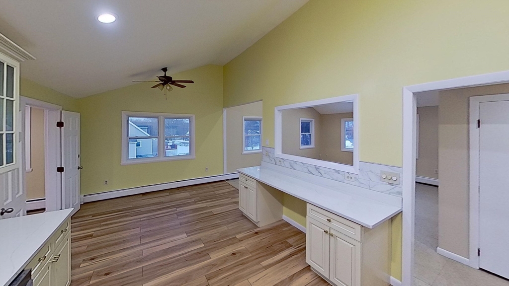 52 Rockefeller Street, Unit 2 Randolph, MA 02368 - Photo 3 of 9 a view of an empty room with window and wooden floor