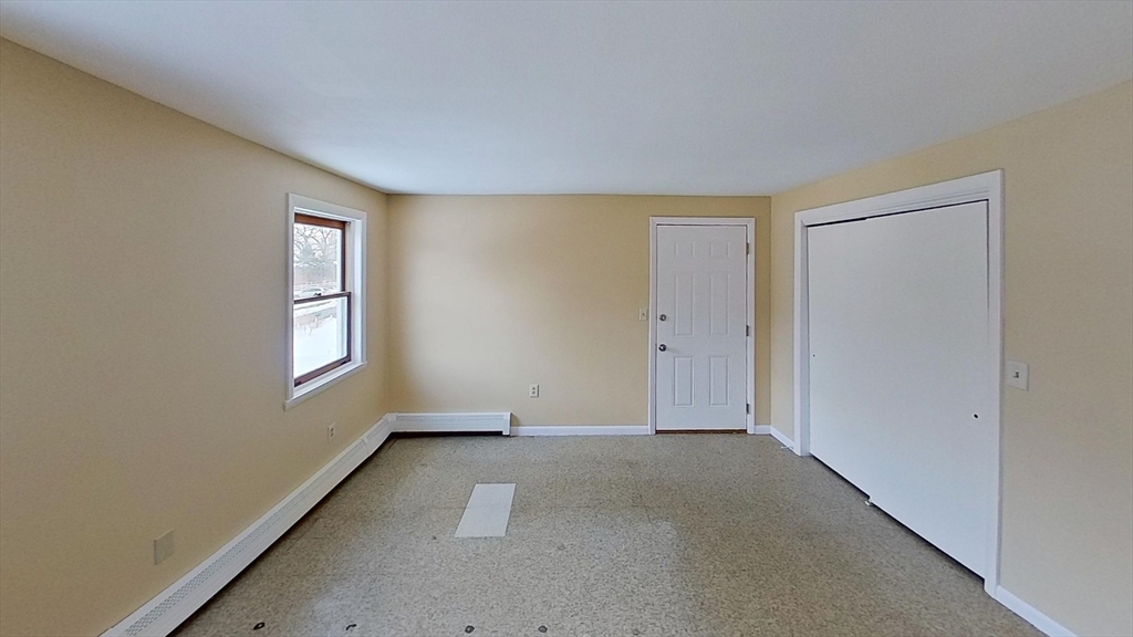 52 Rockefeller Street, Unit 2 Randolph, MA 02368 - Photo 7 of 9 an empty room with windows