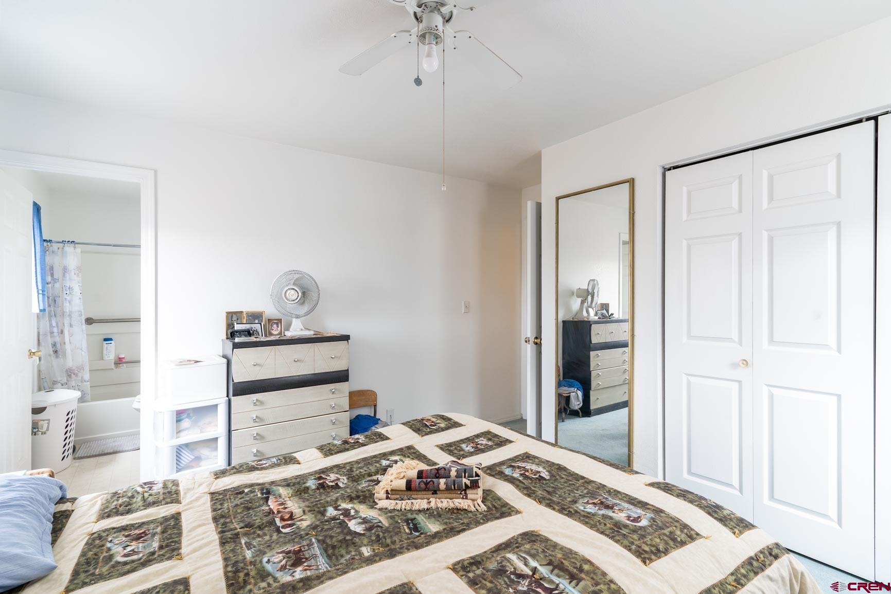 4 North Dolores Road Cortez, CO 81321 - Photo 14 of 24 a view of a bedroom with wooden floor and ceiling fan