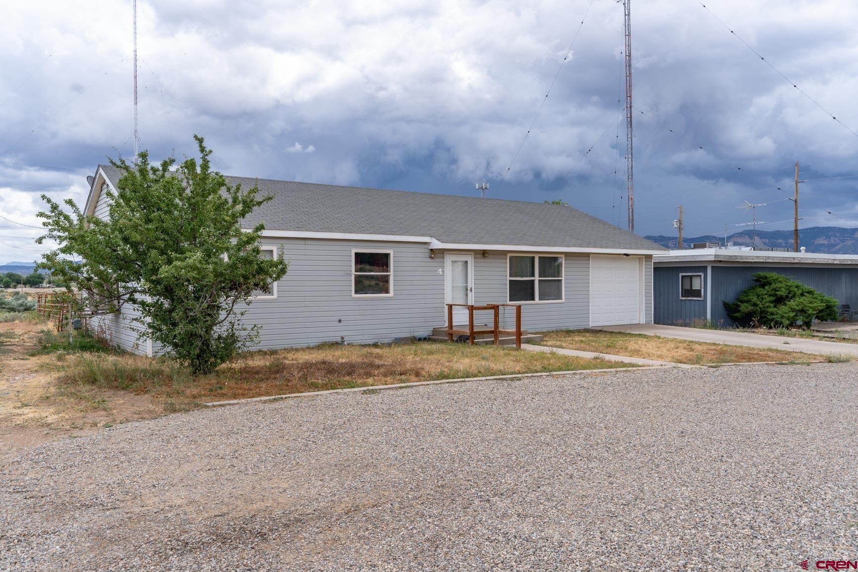 4 North Dolores Road Cortez, CO 81321 - Photo 16 of 24 a view of a house with a backyard and a tree
