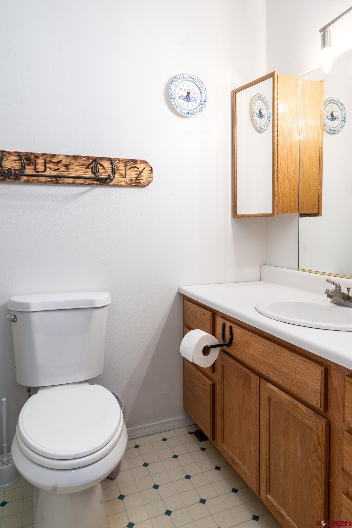 4 North Dolores Road Cortez, CO 81321 - Photo 20 of 24 a bathroom with a sink a toilet and mirror