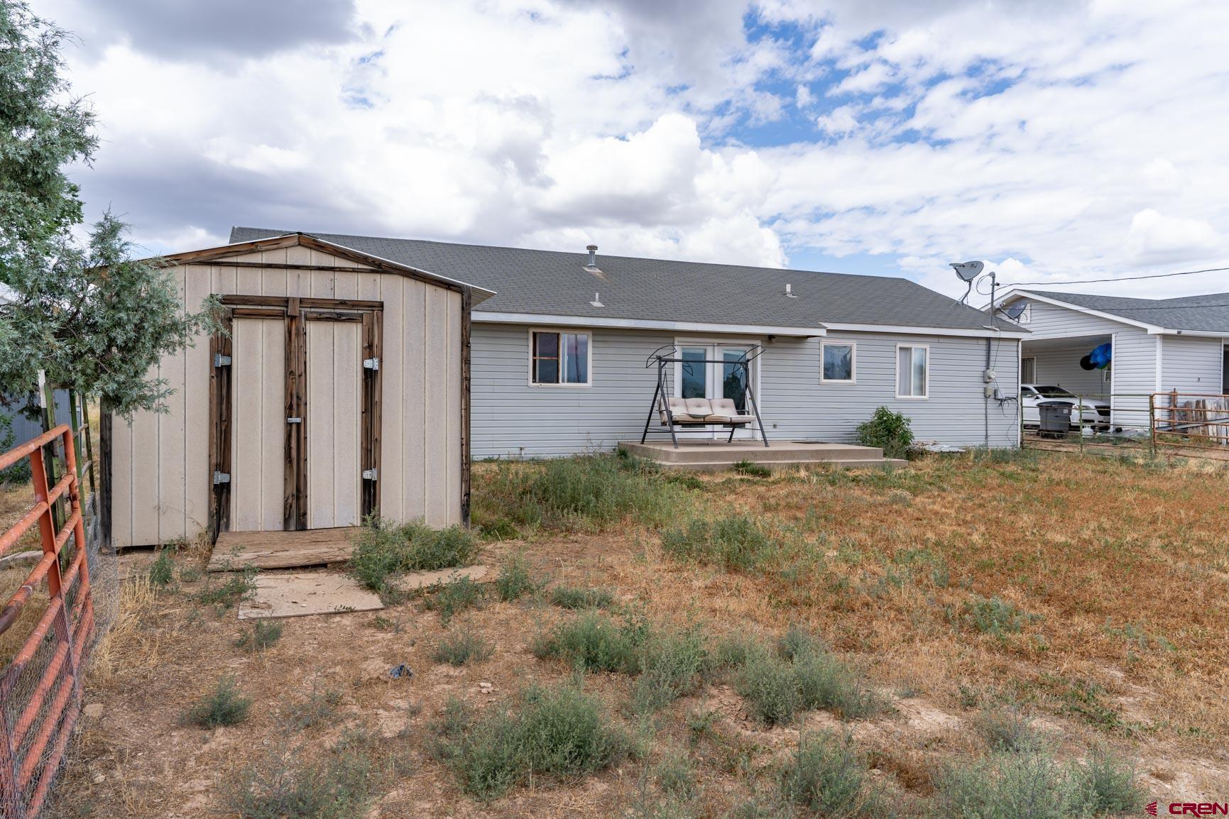4 North Dolores Road Cortez, CO 81321 - Photo 2 of 24 a front view of house with yard and trees around