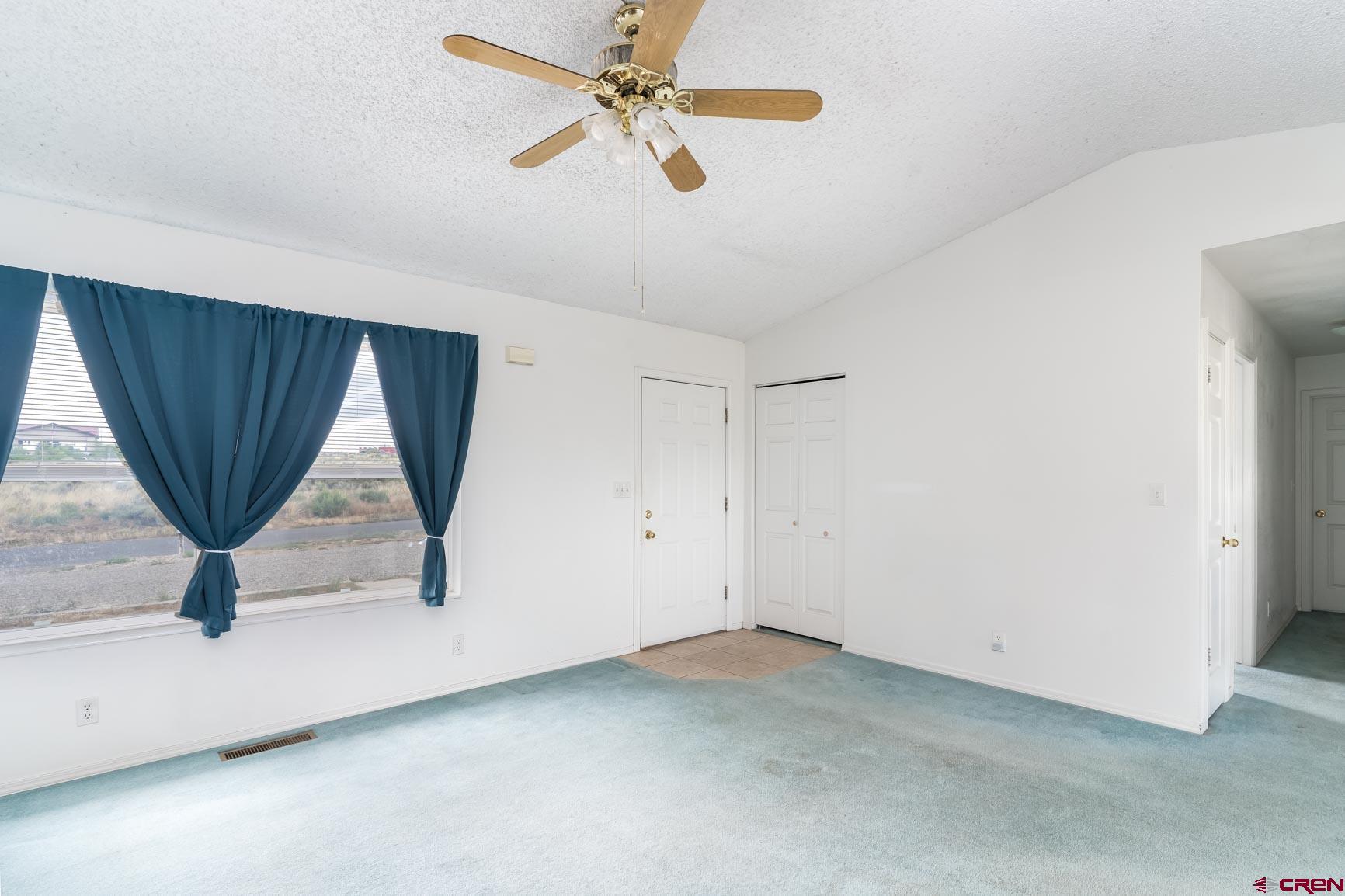 4 North Dolores Road Cortez, CO 81321 - Photo 4 of 24 a view of room with a ceiling fan and window