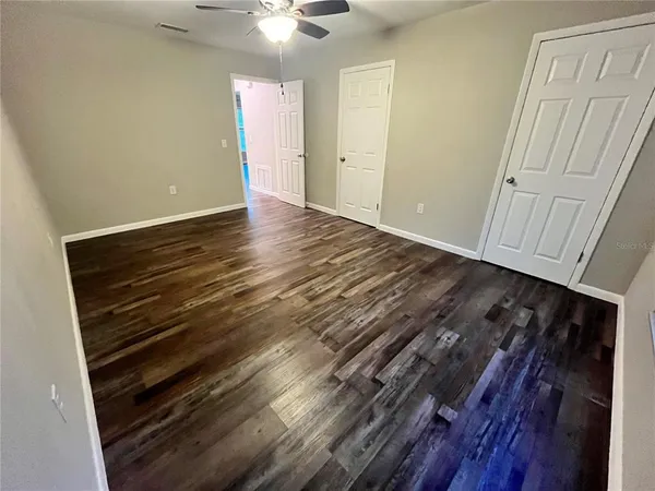 a view of an empty room and wooden floor