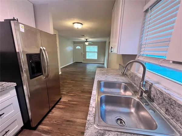 a kitchen with a sink and refrigerator