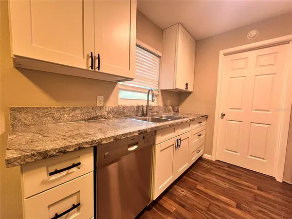 a kitchen with stainless steel appliances granite countertop a sink and a stove