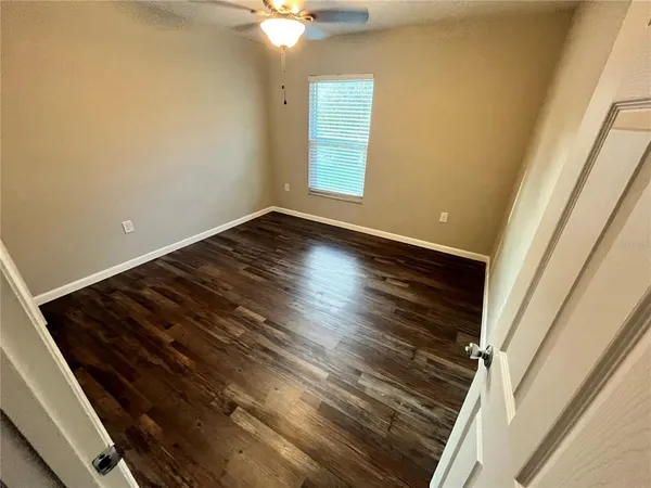 a view of an empty room and wooden floor