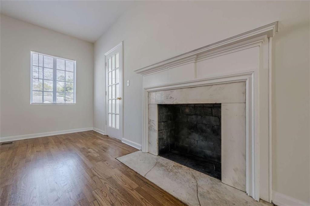 1977 North Decatur Road Atlanta, GA 30307 - Photo 10 of 59 an empty room with wooden floor fireplace and windows